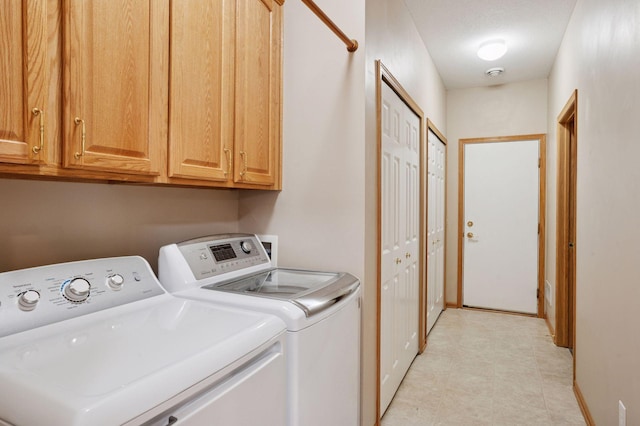 laundry room with cabinet space and washer and dryer