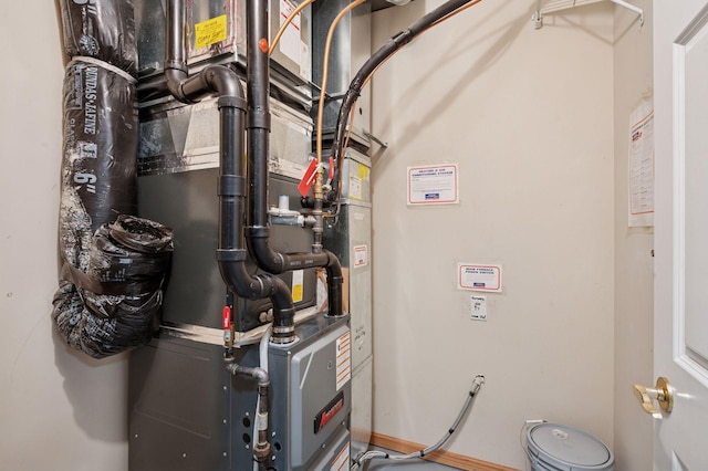 utility room featuring heating unit