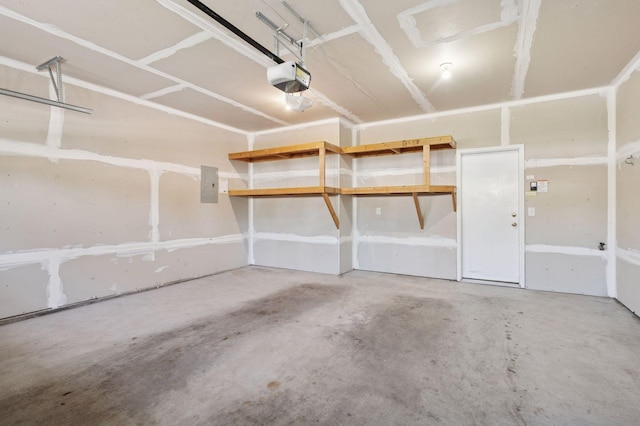 garage with a garage door opener and electric panel
