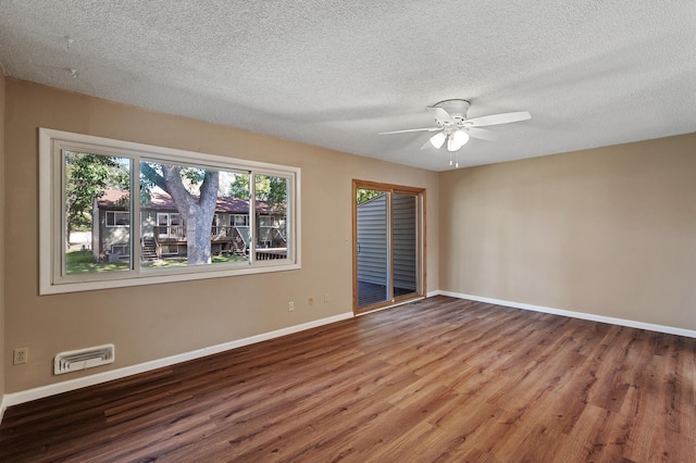10276 Hanson Blvd NW, Coon Rapids, MN 55433 - empty room with wood finished floors, baseboards, ceiling fan, and a textured ceiling