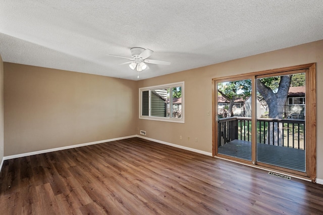 10276 Hanson Blvd NW, Coon Rapids, MN 55433 - empty room with wood finished floors, baseboards, a ceiling fan, and a textured ceiling