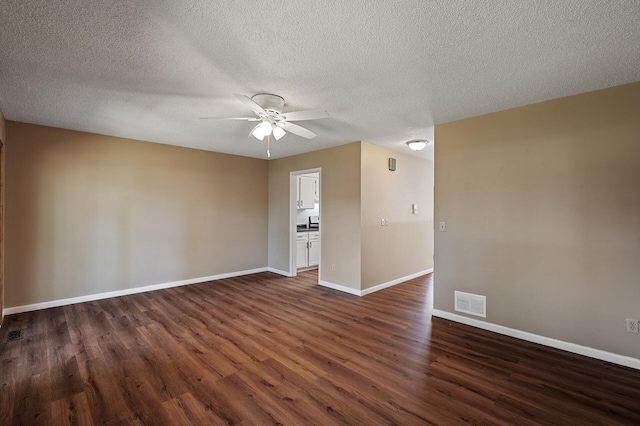 10276 Hanson Blvd NW, Coon Rapids, MN 55433 - empty room with dark wood finished floors, a ceiling fan, baseboards, and a textured ceiling