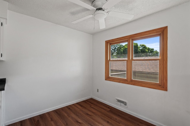 10276 Hanson Blvd NW, Coon Rapids, MN 55433 - empty room featuring baseboards, dark wood finished floors, a textured ceiling, and ceiling fan