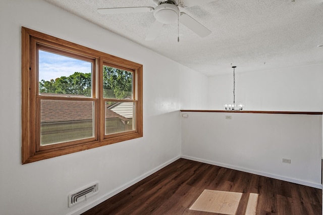 10276 Hanson Blvd NW, Coon Rapids, MN 55433 - spare room featuring a textured ceiling, dark wood finished floors, a chandelier, baseboards, and a ceiling fan