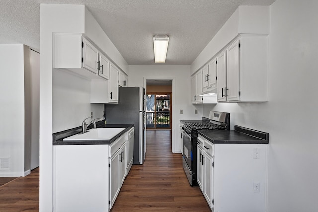 10276 Hanson Blvd NW, Coon Rapids, MN 55433 - kitchen featuring stainless steel appliances, a sink, dark countertops, under cabinet range hood, and a textured ceiling