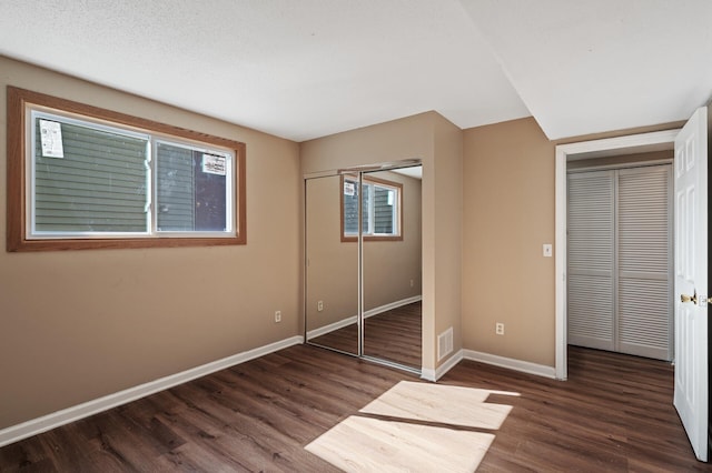 10276 Hanson Blvd NW, Coon Rapids, MN 55433 - unfurnished bedroom featuring baseboards and wood finished floors