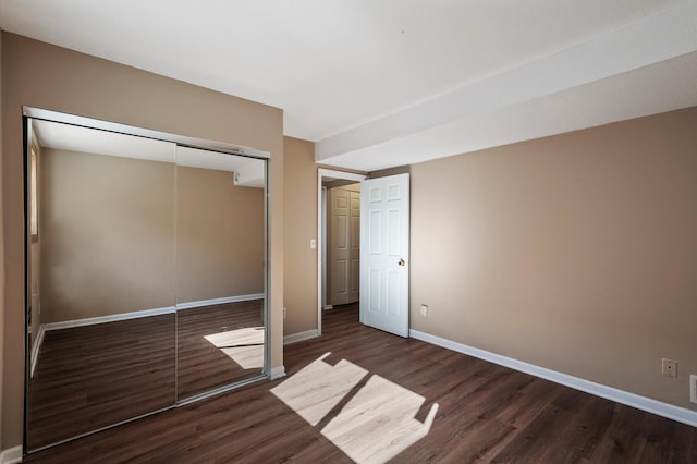 10276 Hanson Blvd NW, Coon Rapids, MN 55433 - unfurnished bedroom featuring wood finished floors, baseboards, and a closet