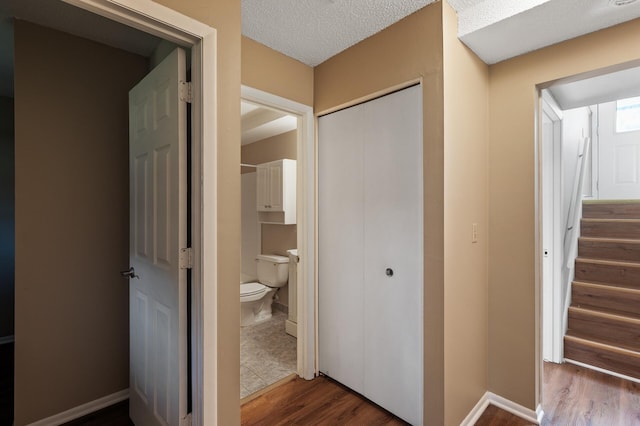 10276 Hanson Blvd NW, Coon Rapids, MN 55433 - corridor featuring wood finished floors, stairs, and a textured ceiling