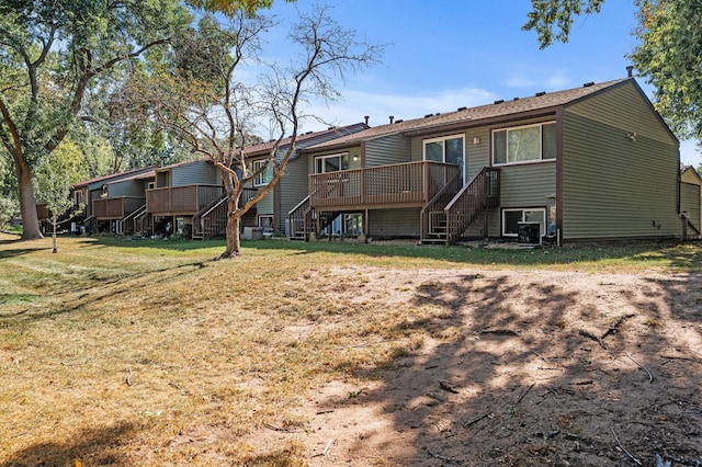 10276 Hanson Blvd NW, Coon Rapids, MN 55433 - rear view of property with stairway, a deck, and a lawn