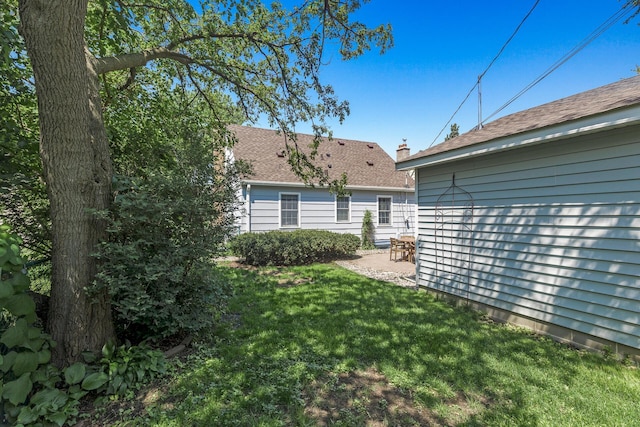 3259 Zarthan Ave S, Saint Louis Park, MN 55416 - back of property with a lawn, a shingled roof, and a patio area