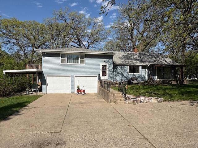 1300 10th St NE, Sauk Rapids Twp, MN 56379 - tri-level home featuring an attached garage, driveway, and a front yard