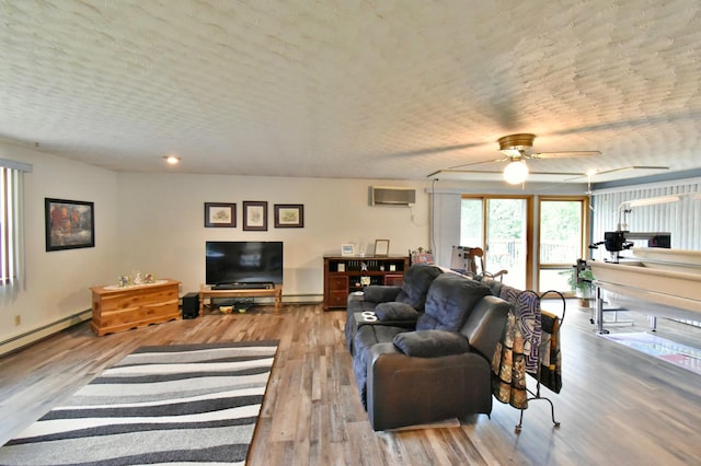 1300 10th St NE, Sauk Rapids Twp, MN 56379 - living room with ceiling fan, wood finished floors, an AC wall unit, and a baseboard radiator
