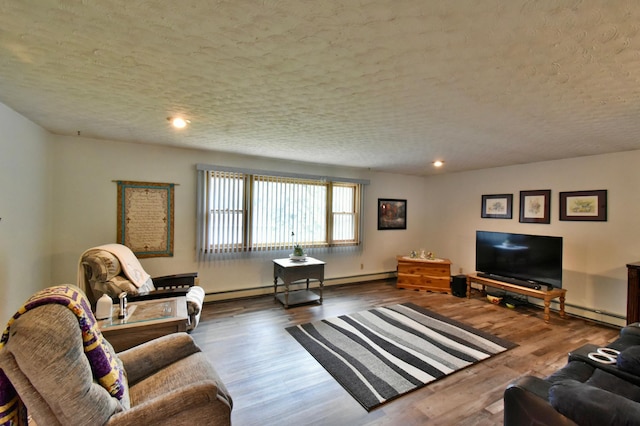 1300 10th St NE, Sauk Rapids Twp, MN 56379 - living area with baseboard heating, wood finished floors, recessed lighting, and a textured ceiling