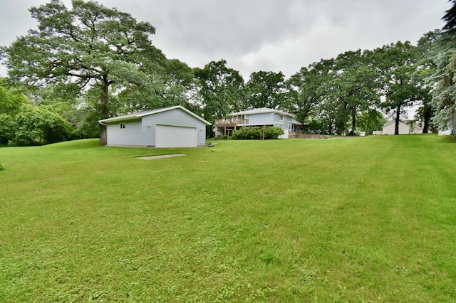 1300 10th St NE, Sauk Rapids Twp, MN 56379 - view of grassy yard with a garage, an outbuilding, and view of wooded area