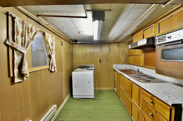 1300 10th St NE, Sauk Rapids Twp, MN 56379 - laundry area with washer / clothes dryer, carpet flooring, wood walls, and baseboard heating