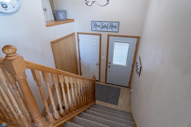 foyer with stairs and a chandelier