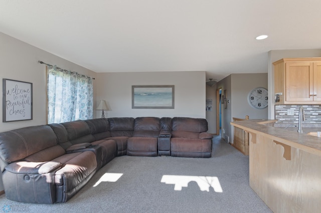 living room with light colored carpet and recessed lighting