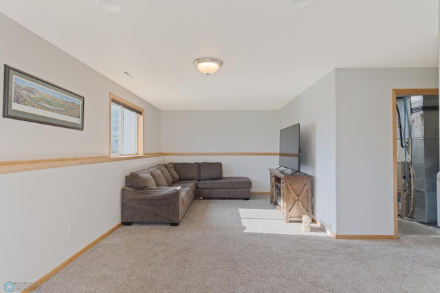 carpeted living room with baseboards