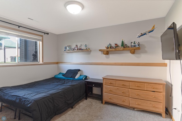 bedroom featuring light colored carpet