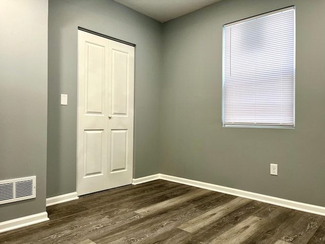 2616 30th Ave S, Minneapolis, MN 55406 - spare room featuring dark wood-type flooring and baseboards