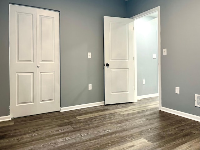 2616 30th Ave S, Minneapolis, MN 55406 - unfurnished bedroom with baseboards, dark wood finished floors, and a closet