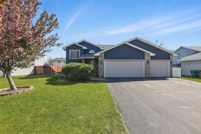 6609 91st Trl N, Brooklyn Park, MN 55445 - view of front of home with asphalt driveway, an attached garage, and brick siding