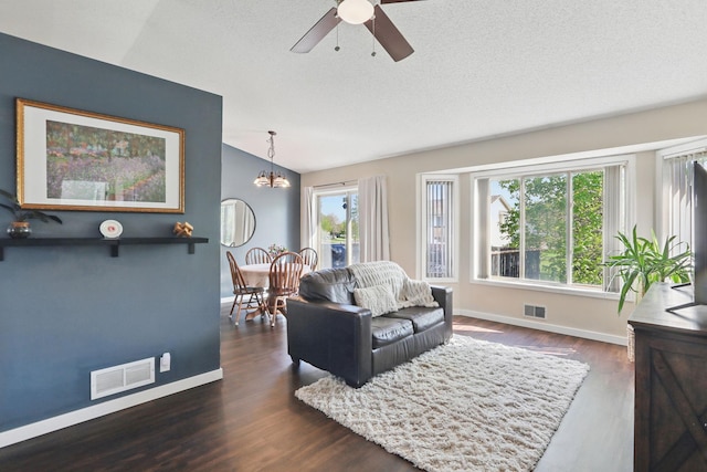 6609 91st Trl N, Brooklyn Park, MN 55445 - living room with lofted ceiling, ceiling fan, baseboards, a chandelier, and wood finished floors