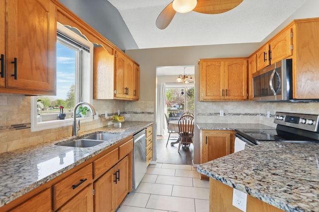 6609 91st Trl N, Brooklyn Park, MN 55445 - kitchen featuring stainless steel appliances, a sink, light stone counters, a ceiling fan, and tasteful backsplash