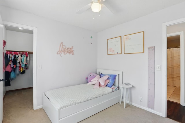 6609 91st Trl N, Brooklyn Park, MN 55445 - carpeted bedroom featuring a spacious closet, baseboards, a ceiling fan, and a closet