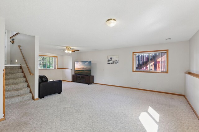 6609 91st Trl N, Brooklyn Park, MN 55445 - carpeted living room featuring stairs, a ceiling fan, and baseboards