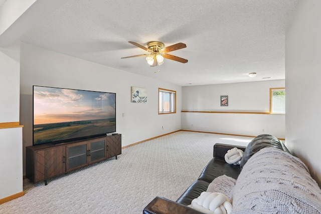 6609 91st Trl N, Brooklyn Park, MN 55445 - carpeted living area featuring a ceiling fan, baseboards, and a textured ceiling