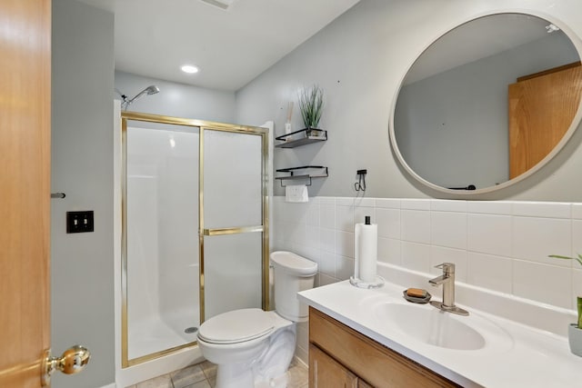 6609 91st Trl N, Brooklyn Park, MN 55445 - bathroom featuring a stall shower, toilet, vanity, tile patterned floors, and tile walls
