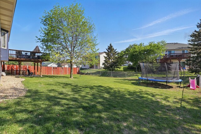 6609 91st Trl N, Brooklyn Park, MN 55445 - view of yard with a trampoline and a wooden deck