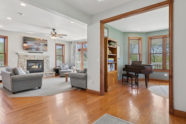 6715 Eldorado Way, Leon Twp, MN 55009 - living room with recessed lighting, baseboards, a ceiling fan, light wood-style floors, and a stone fireplace