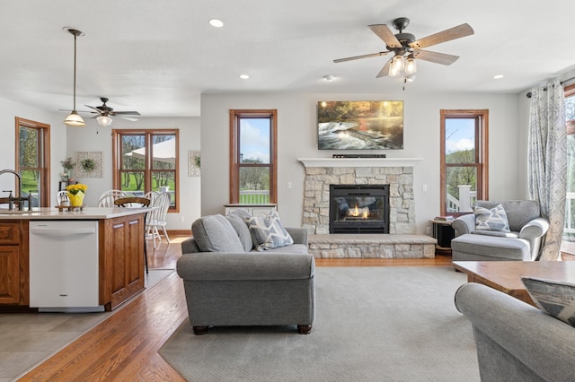 6715 Eldorado Way, Leon Twp, MN 55009 - living area with ceiling fan, a stone fireplace, light wood-style flooring, and recessed lighting