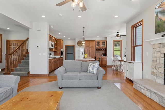 6715 Eldorado Way, Leon Twp, MN 55009 - living room with a ceiling fan, light wood finished floors, recessed lighting, stairway, and a fireplace