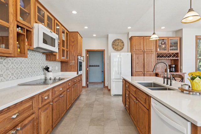 6715 Eldorado Way, Leon Twp, MN 55009 - kitchen featuring white appliances, a sink, brown cabinets, decorative backsplash, and recessed lighting