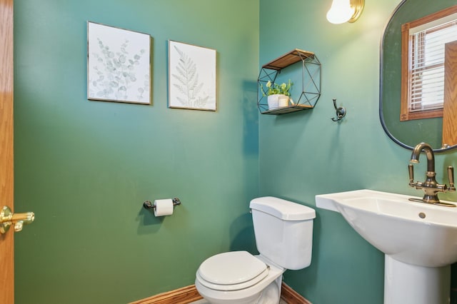 6715 Eldorado Way, Leon Twp, MN 55009 - bathroom featuring toilet, baseboards, and a sink