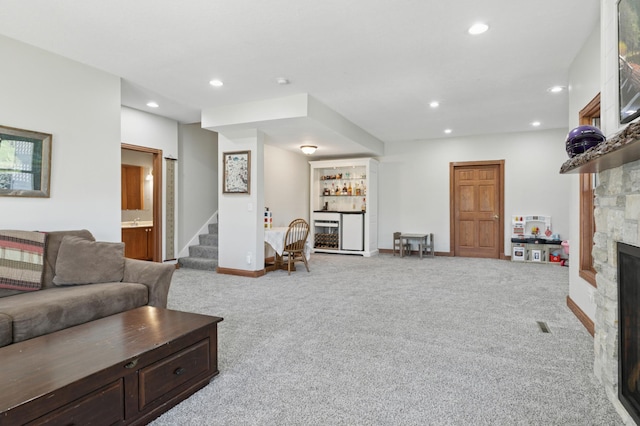 6715 Eldorado Way, Leon Twp, MN 55009 - living area featuring carpet floors, a fireplace, recessed lighting, a dry bar, and stairway