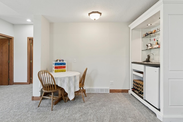 6715 Eldorado Way, Leon Twp, MN 55009 - carpeted dining area featuring a bar, baseboards, and recessed lighting