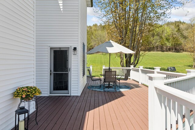 6715 Eldorado Way, Leon Twp, MN 55009 - wooden deck featuring outdoor dining space and a lawn