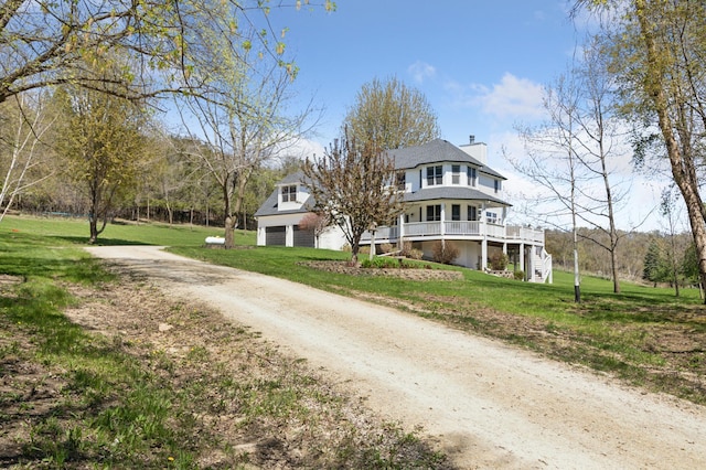 6715 Eldorado Way, Leon Twp, MN 55009 - view of front of house with a garage, a chimney, dirt driveway, and a front lawn