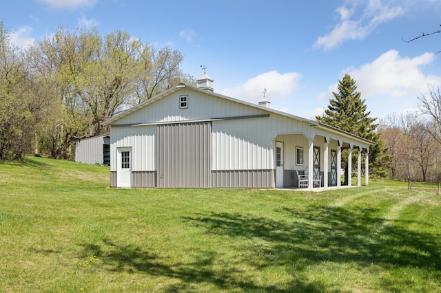 6715 Eldorado Way, Leon Twp, MN 55009 - back of house with a yard, a chimney, a detached garage, and an outdoor structure