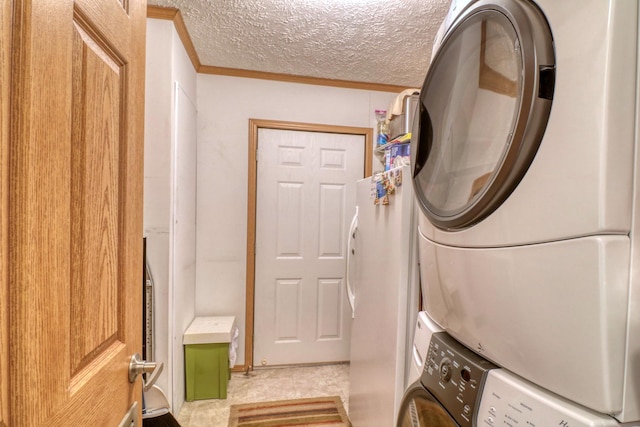 33397 Pickerel View Dr, Richville, MN 56576 - clothes washing area featuring stacked washing machine and dryer, ornamental molding, and a textured ceiling