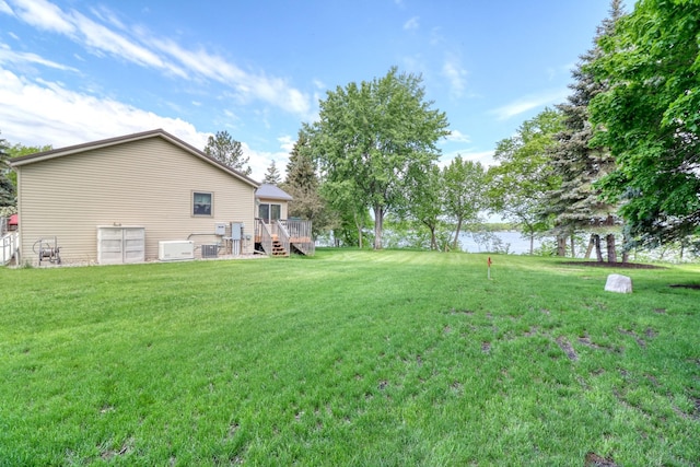 33397 Pickerel View Dr, Richville, MN 56576 - view of grassy yard with a deck with water view and central AC unit