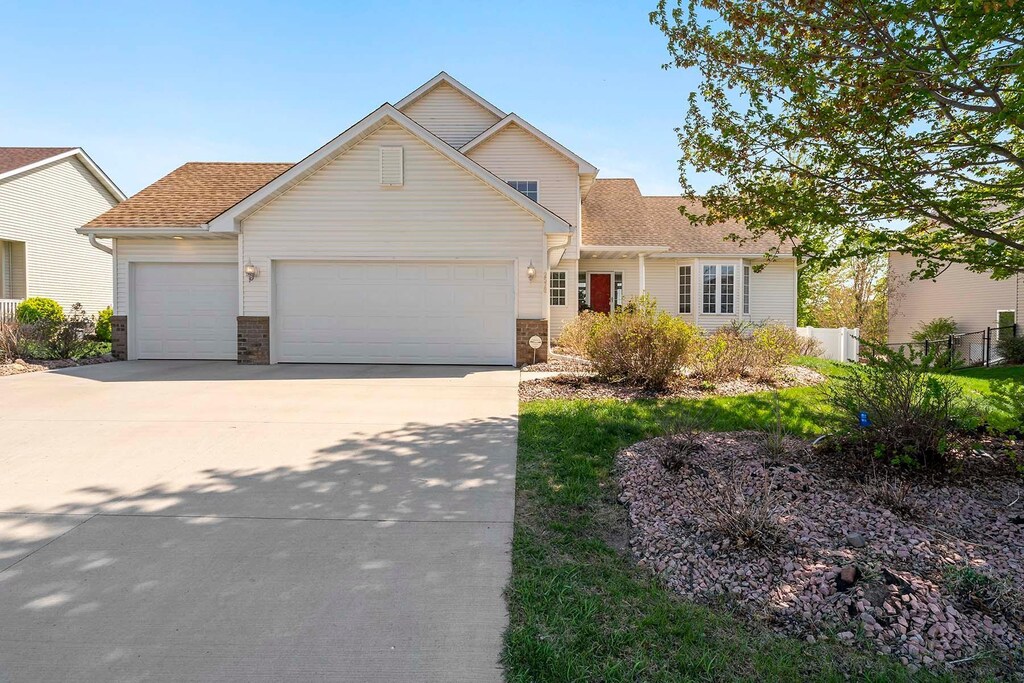 2578 148th St W, Rosemount, MN 55068 - traditional home with an attached garage, driveway, fence, and a shingled roof