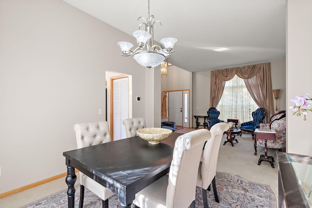 carpeted dining room with a chandelier, lofted ceiling, and baseboards