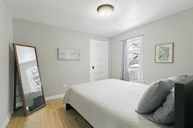 1541 Charles Ave, Saint Paul, MN 55104 - bedroom featuring light wood-type flooring, baseboards, and cooling unit