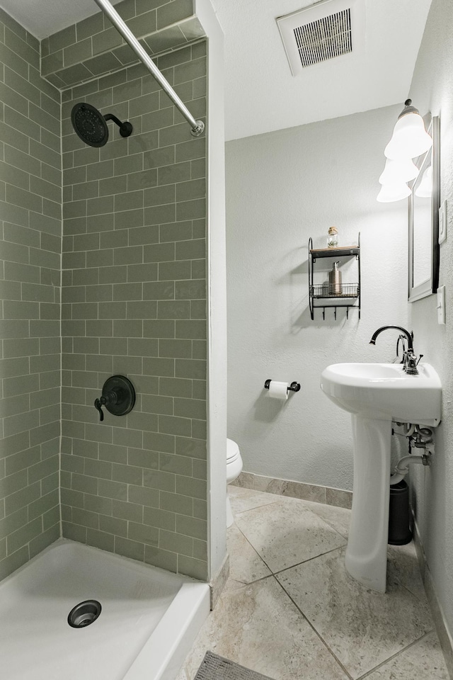 1541 Charles Ave, Saint Paul, MN 55104 - bathroom featuring a stall shower, baseboards, and toilet