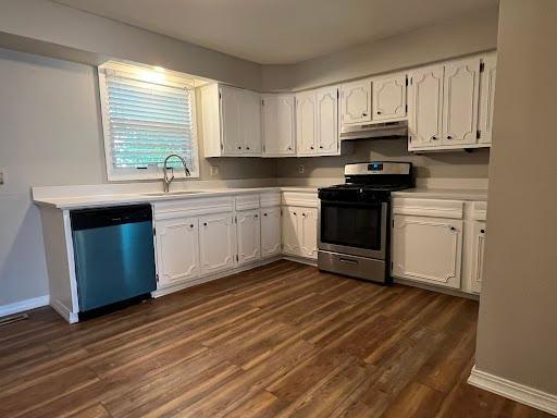 1541 Charles Ave, Saint Paul, MN 55104 - kitchen featuring dishwasher, stainless steel gas range, under cabinet range hood, white cabinetry, and a sink